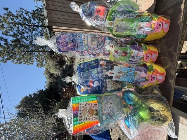 Wrapped Easter baskets and prizes lined up on a table