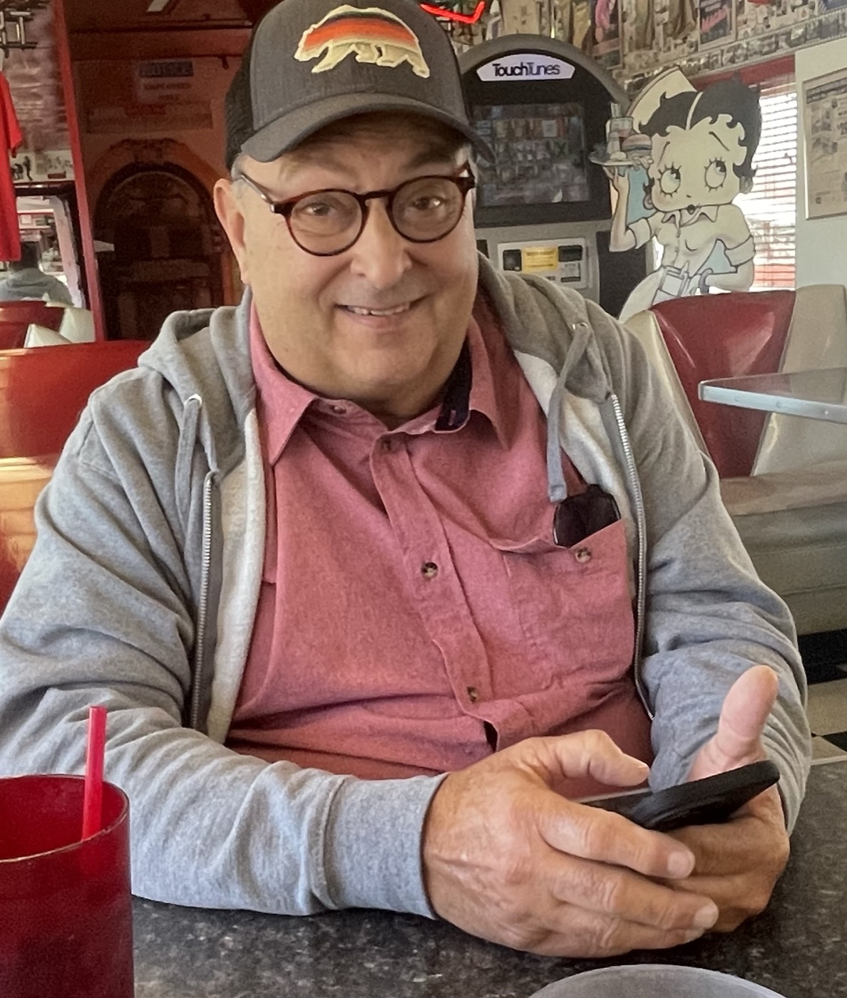 Russ Drew smiling at a table in a local diner
